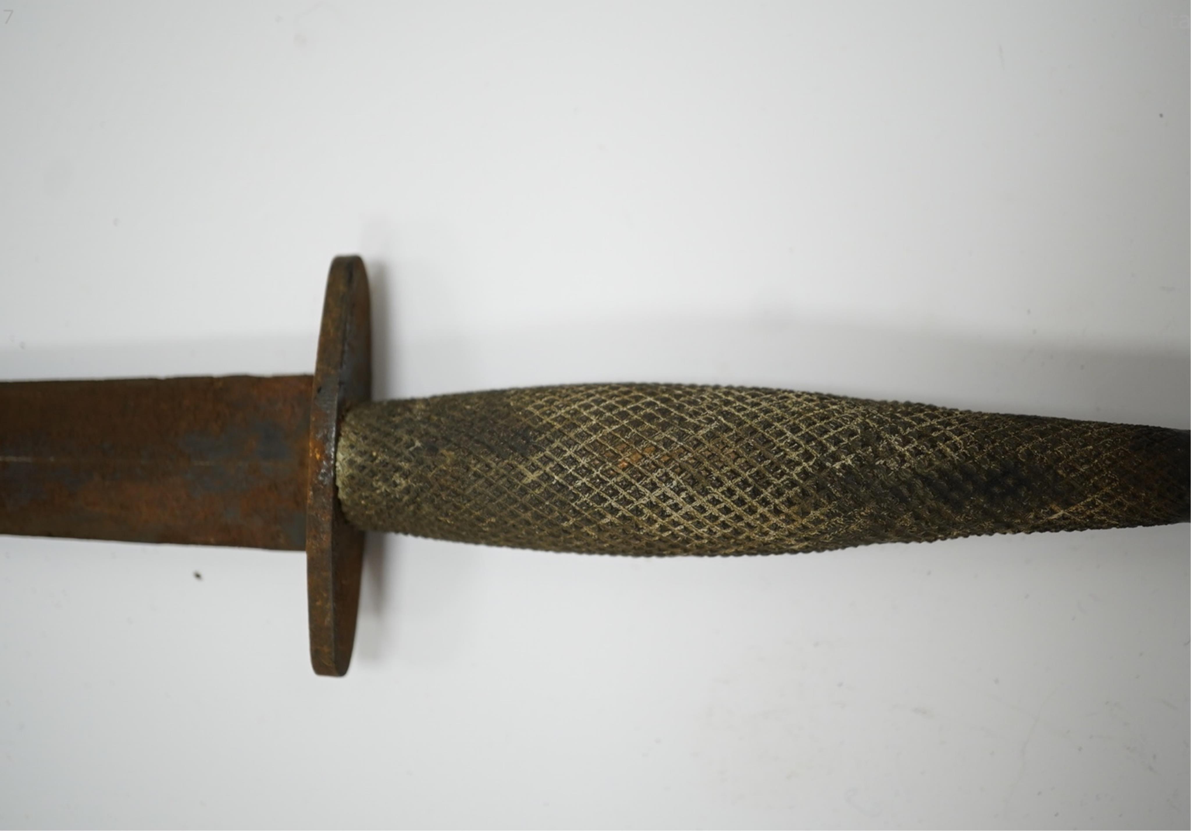 A WW2 US OSS Commando fighting knife (with broken tip), blade 14.5cm, and a spatula sheath. Condition - poor, broken tip and considerable surface rust, etc.